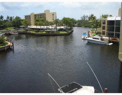 a view of a lake with boats and trees in the background
