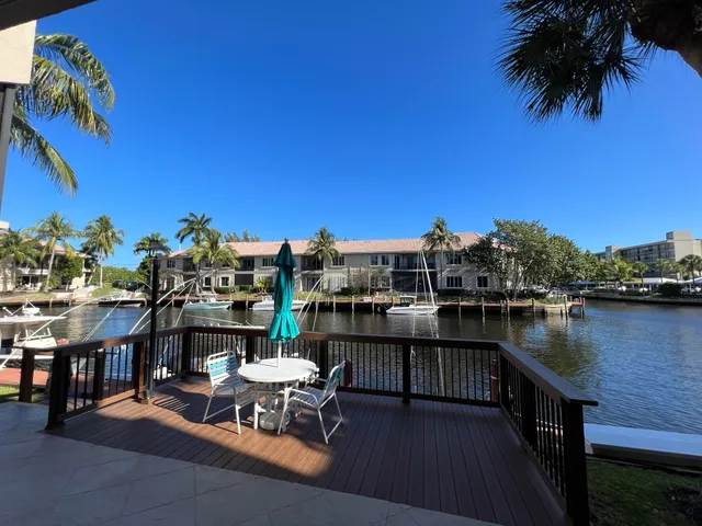 a view of a lake with a table and chairs