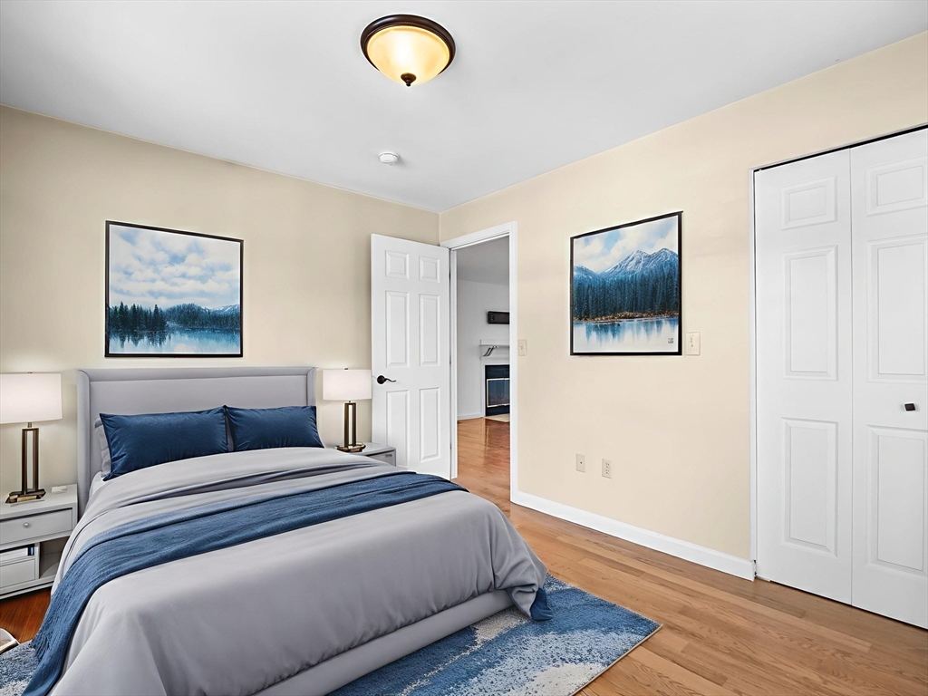 600 County Street, Unit 404 Taunton, MA 02780 - Photo 12 of 26 a bedroom with a large bed and a painting on the wall