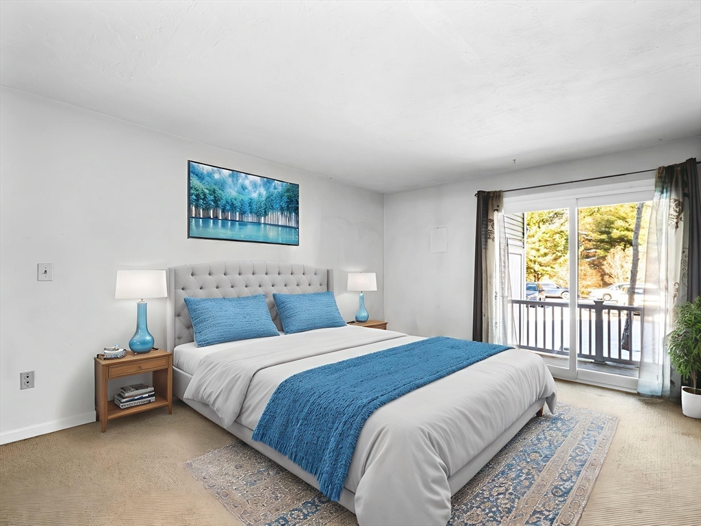 600 County Street, Unit 404 Taunton, MA 02780 - Photo 15 of 26 a bedroom with a bed a couch and a window