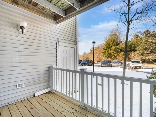 a view of a balcony with wooden floor and fence
