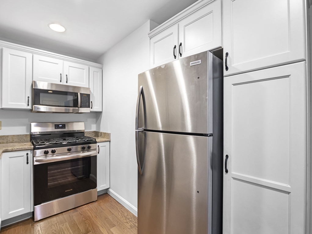 600 County Street, Unit 404 Taunton, MA 02780 - Photo 3 of 26 a white refrigerator freezer and a stove top oven