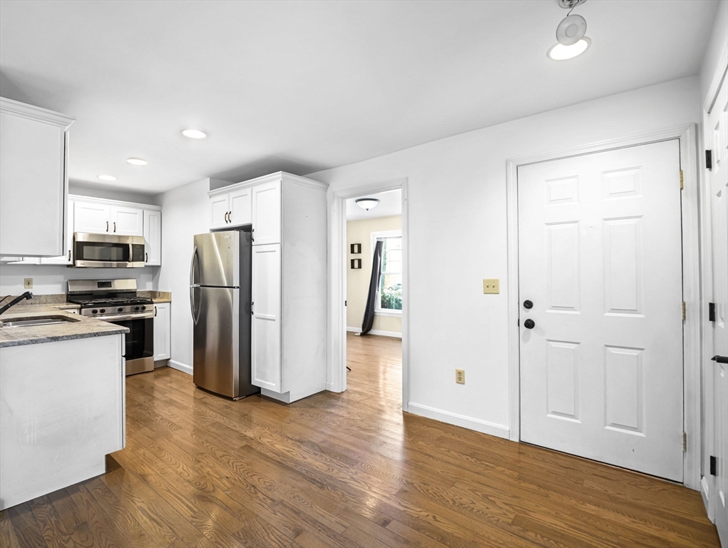 600 County Street, Unit 404 Taunton, MA 02780 - Photo 6 of 26 a view of a kitchen with refrigerator and wooden floor