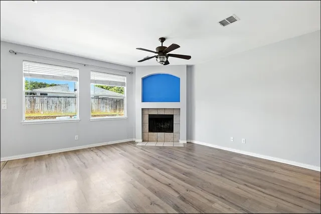 wooden floor in an empty room with a window