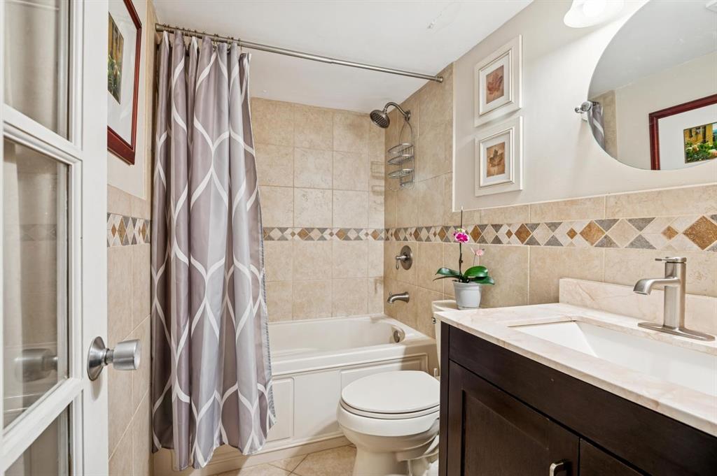 2249 Southwest 15th Street, Unit 185 Deerfield Beach, FL 33442 - Photo 11 of 31 a bathroom with a granite countertop sink toilet and shower