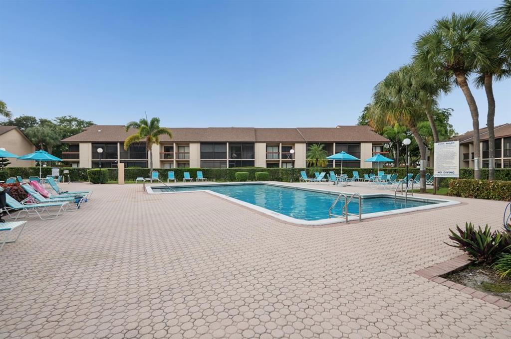 2249 Southwest 15th Street, Unit 185 Deerfield Beach, FL 33442 - Photo 18 of 31 a view of pool with outdoor seating