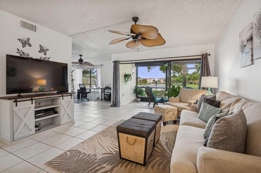 2249 Southwest 15th Street, Unit 185 Deerfield Beach, FL 33442 - Photo 4 of 31 a living room with furniture and a flat screen tv