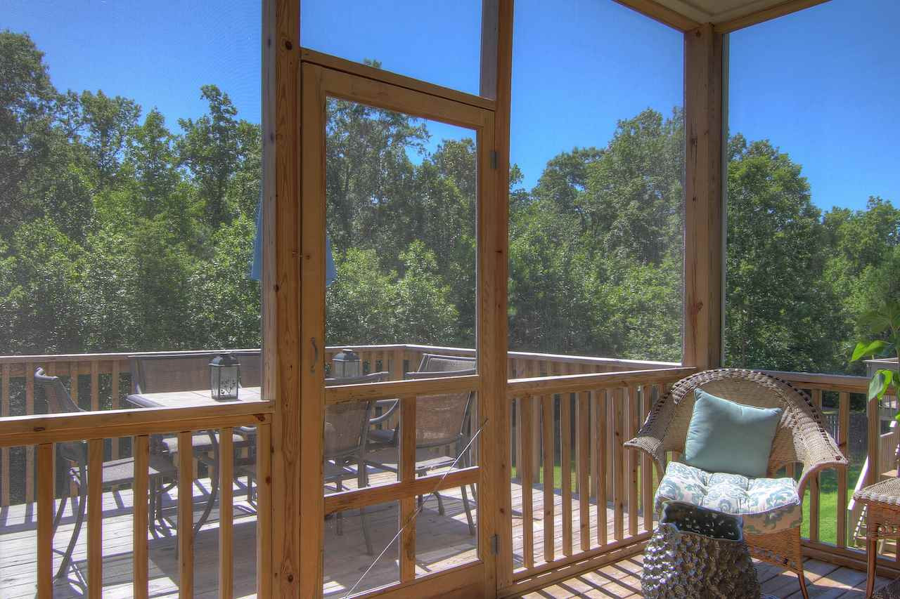 8333 Henderson Road Apex, NC 27539 - Photo 24 of 25 The screened porch and deck area are the perfect spot to enjoy a cup of coffee, dine al fresco or enjoy the views of the backyard. Screened Porch/Deck