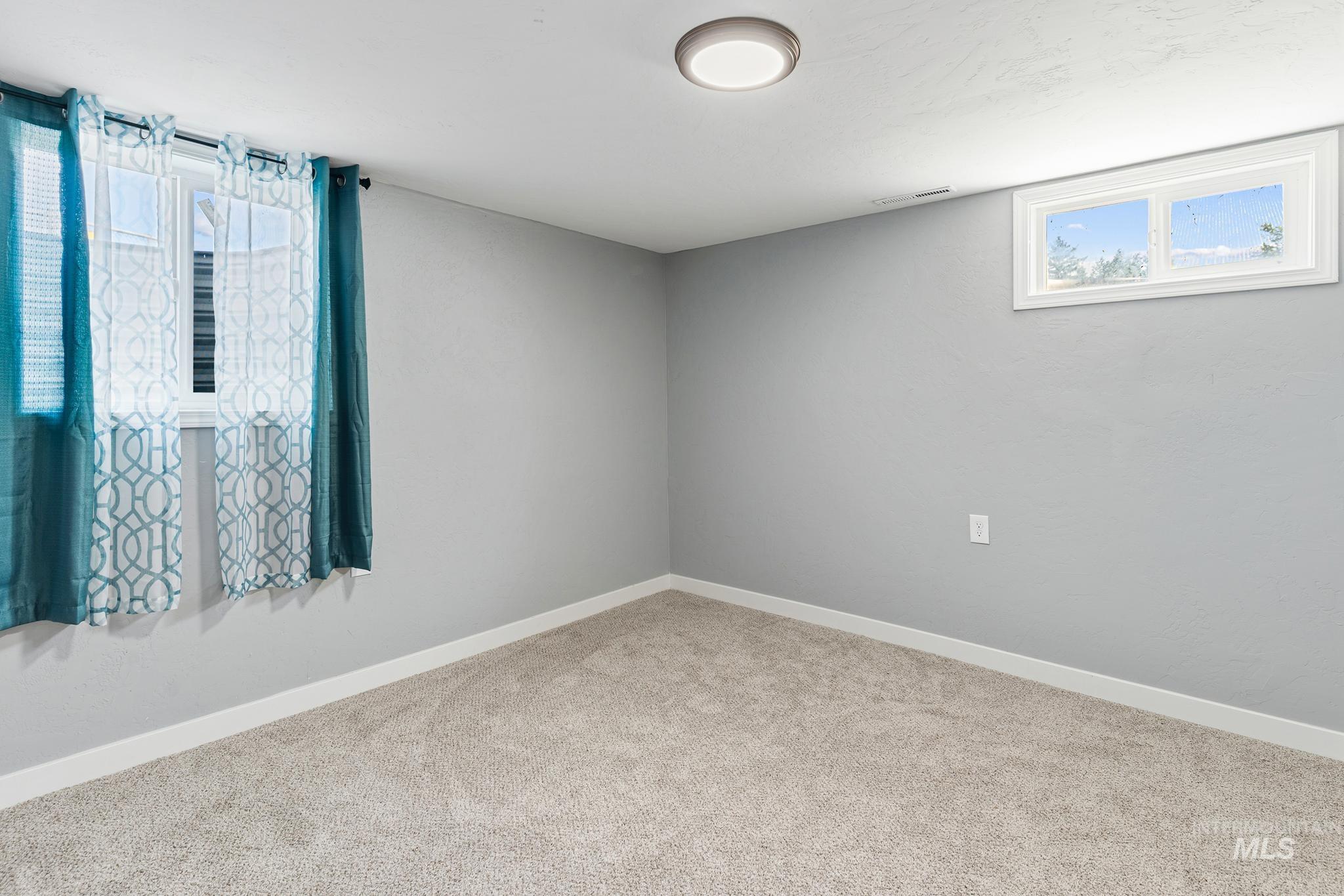 619 Thain Road Lewiston, ID 83501 - Photo 26 of 44 Light gray walls with white trim and neutral carpet flooring