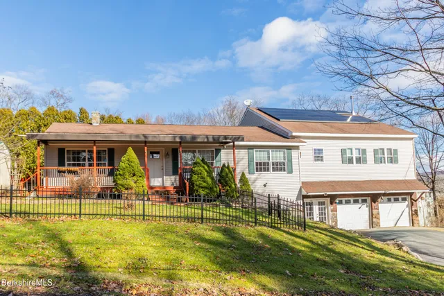a front view of house with a garden