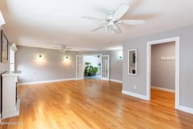 a view of a room with wooden floor and a window