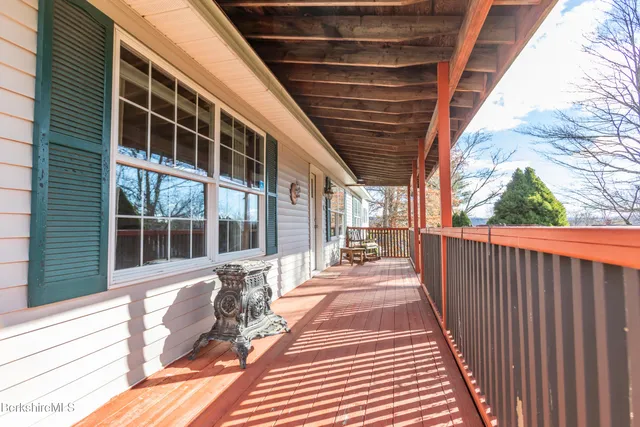 a view of a porch with wooden floor and fence