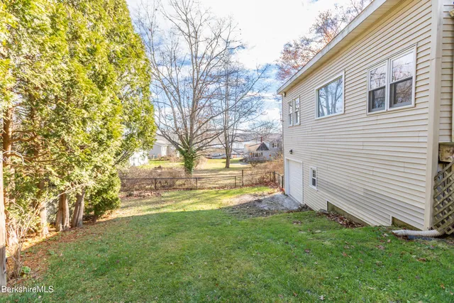 a view of swimming pool with large trees
