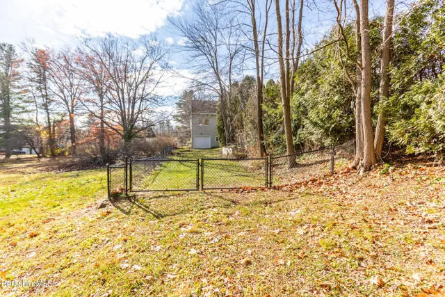 a backyard with table and chairs and couches with wooden roof