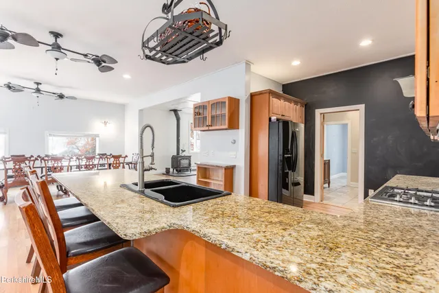 a kitchen with a sink a stove and a refrigerator