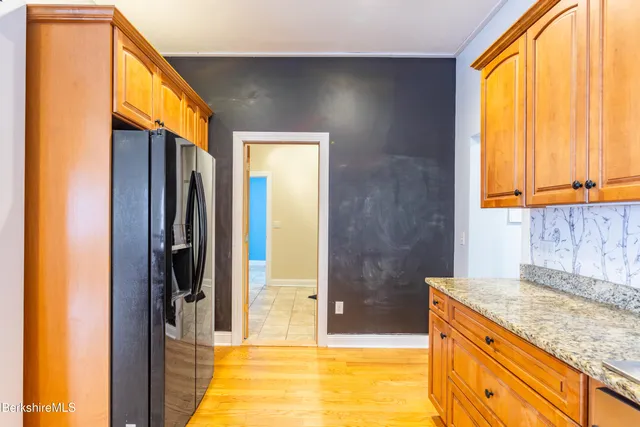 a bathroom with a granite countertop sink and a bathtub