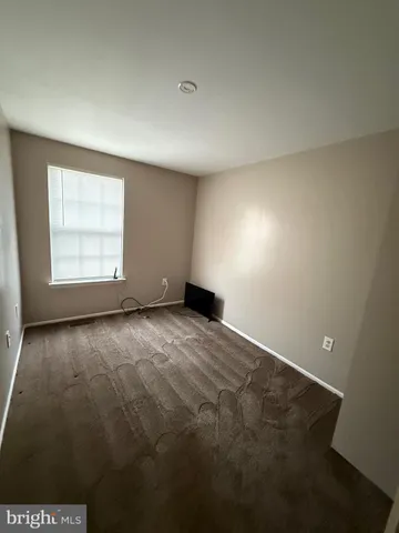 an empty room with a empty space and windows