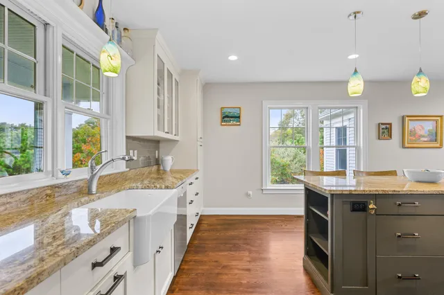 a bathroom with a granite countertop sink a toilet and shower
