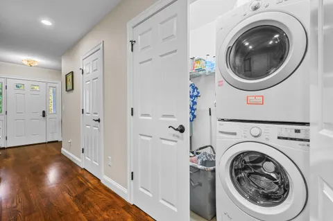 a bathroom with a granite countertop toilet a sink and a window