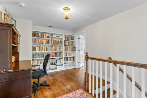 a bed sitting in a bedroom next to a window