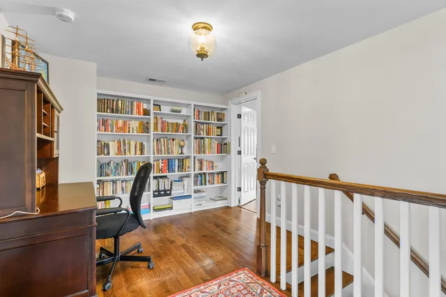 a bed sitting in a bedroom next to a window