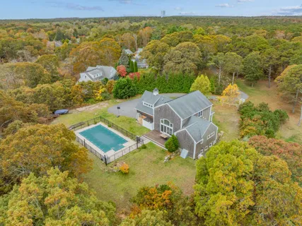 a living room with furniture a fireplace and a large window