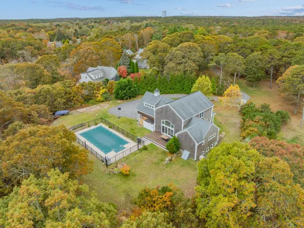 a living room with furniture a fireplace and a large window