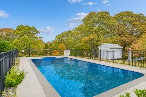 a front view of a house with a yard and trees