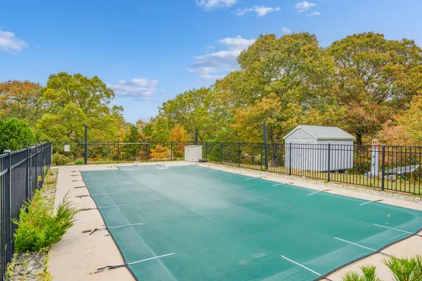 a view of a chair and table in backyard of the house