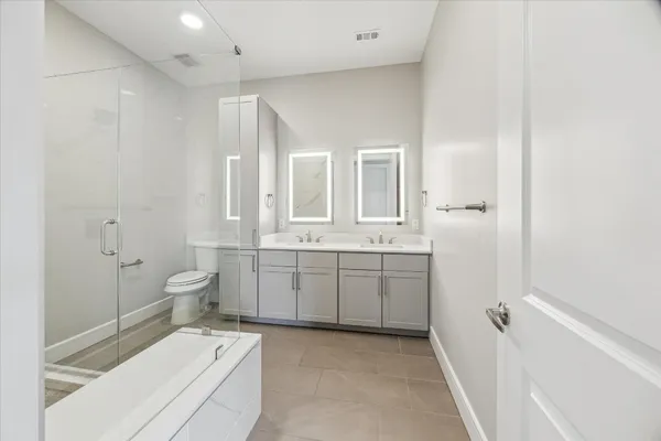 a bathroom with a shower a toilet and sink