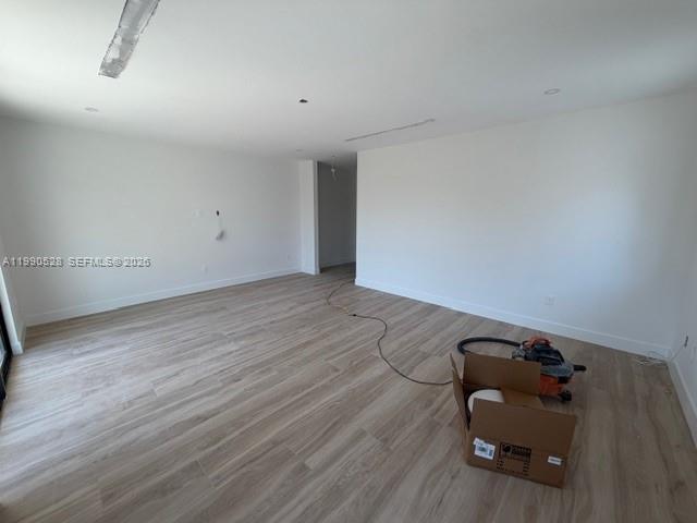 2800 Southwest 38th Court Miami, FL 33134 - Photo 11 of 19 a room with wooden floor and gym equipment