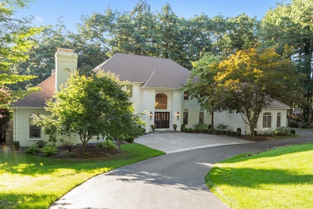 a front view of a house with a yard table and chairs