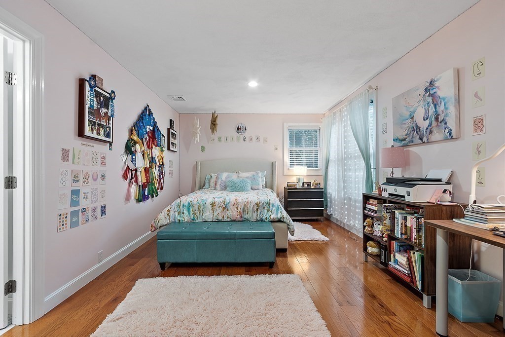 110 Mattison Drive Concord, MA 01742 - Photo 21 of 41 a bedroom with furniture and a wooden floor