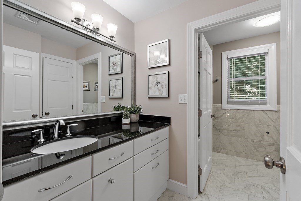 110 Mattison Drive Concord, MA 01742 - Photo 25 of 41 a bathroom with double sink and a mirror