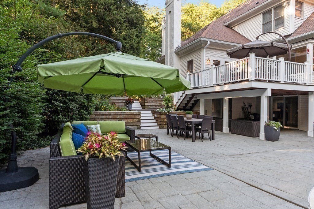 110 Mattison Drive Concord, MA 01742 - Photo 40 of 41 a view of a dining tables and chairs under an umbrella in the patio