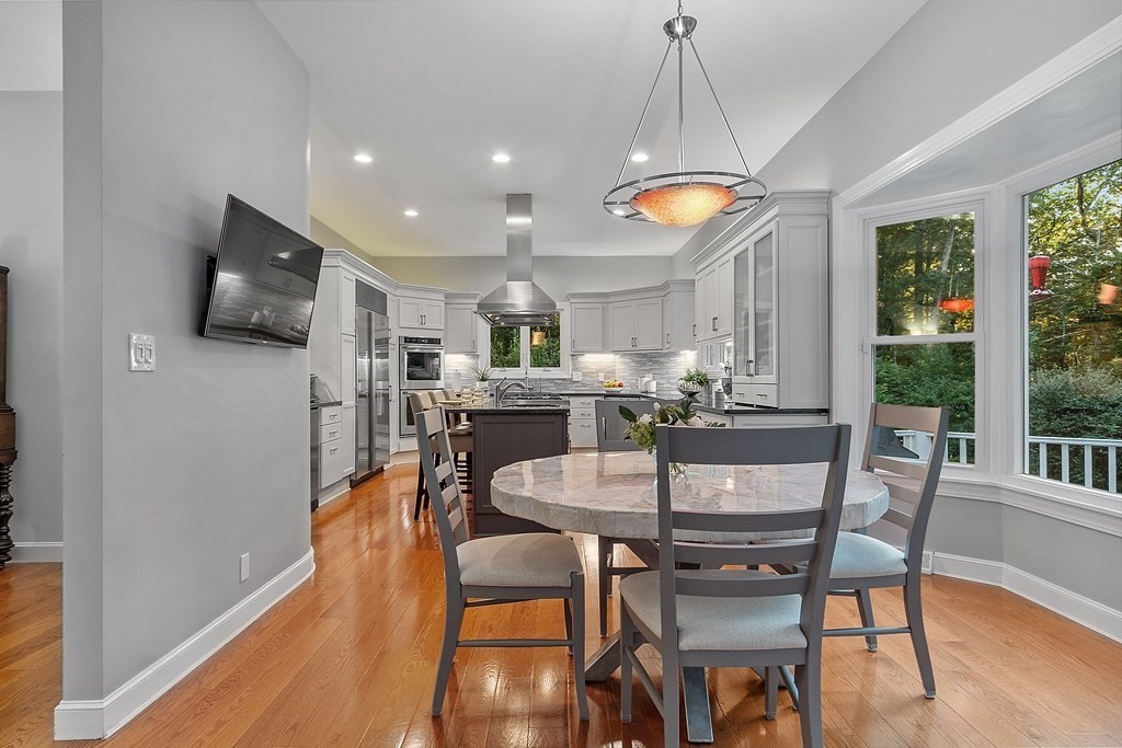 110 Mattison Drive Concord, MA 01742 - Photo 9 of 41 a dining room with furniture and wooden floor