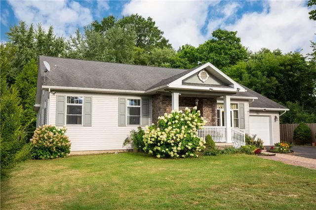 a front view of a house with a garden
