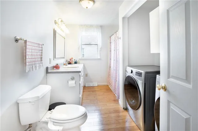 a bathroom with a sink toilet and a mirror