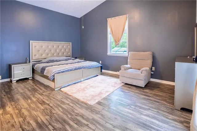 a bedroom with a bed and a couch