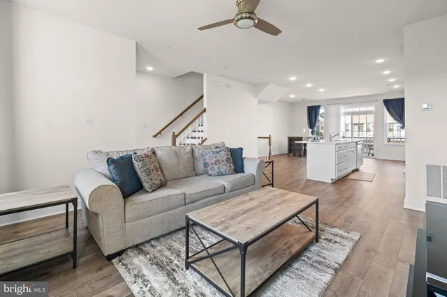 a living room with furniture and kitchen view