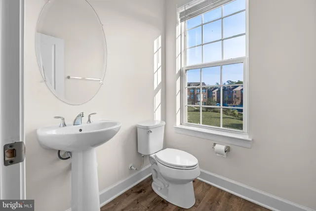 a bathroom with a sink toilet and a mirror