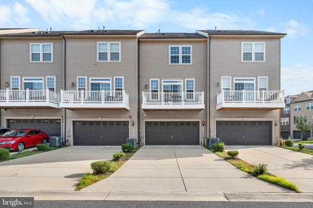 a front view of a house with a yard and a garage