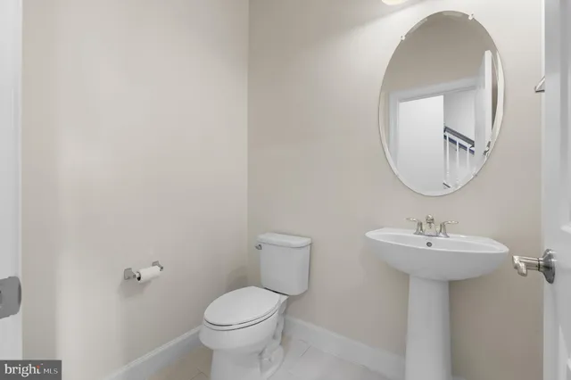 a bathroom with a sink a mirror and toilet