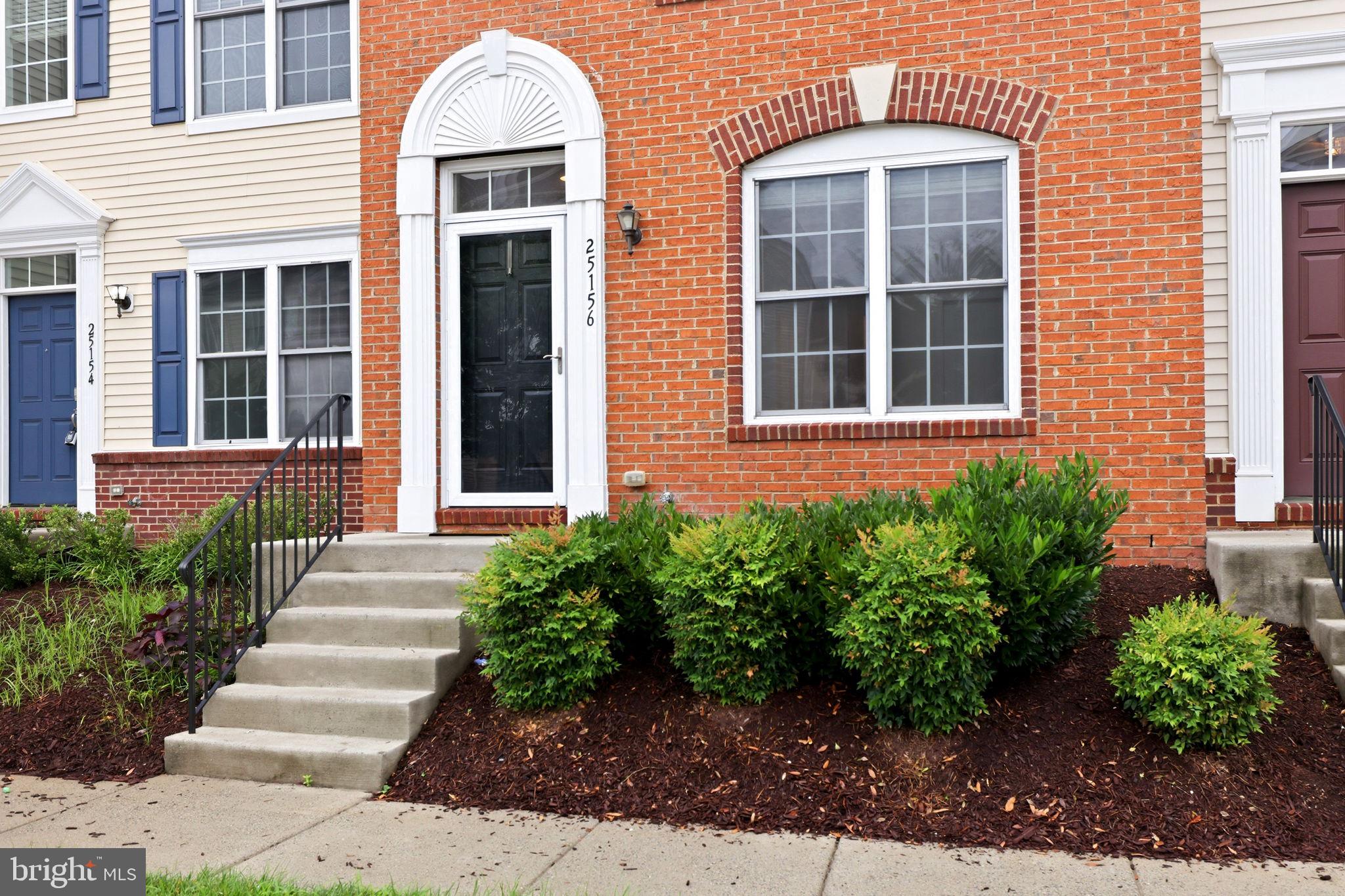 25156 Monteith Terrace Chantilly, VA 20152 - Photo 4 of 72 Charming brick facade with lush greenery.