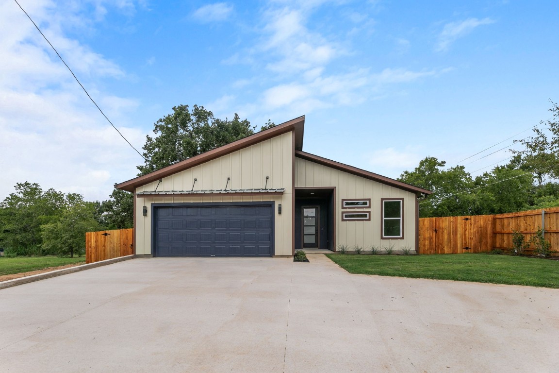 200 Washington Street Elgin, TX 78621 - Photo 1 of 1 a front view of house with yard and trees in the background