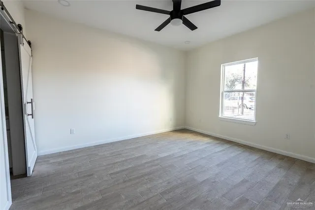 a view of a room with wooden floor and windows