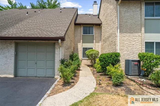 front view of a house with a garden