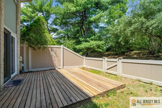 a view of a balcony with wooden floor and fence