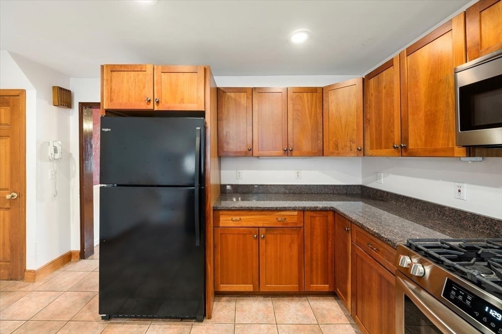 28 Barnesdale Road Natick, MA 01760 - Photo 12 of 33 a kitchen with a refrigerator a stove a microwave and cabinets