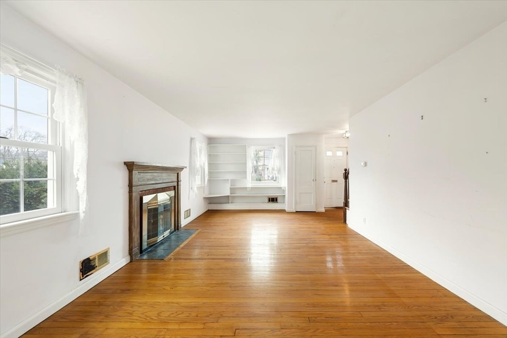 28 Barnesdale Road Natick, MA 01760 - Photo 17 of 33 a view of empty room with wooden floor and fireplace